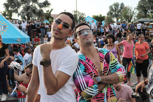 Men with colorful lifeguard nose sunscreen in festive marketplace. sunscre